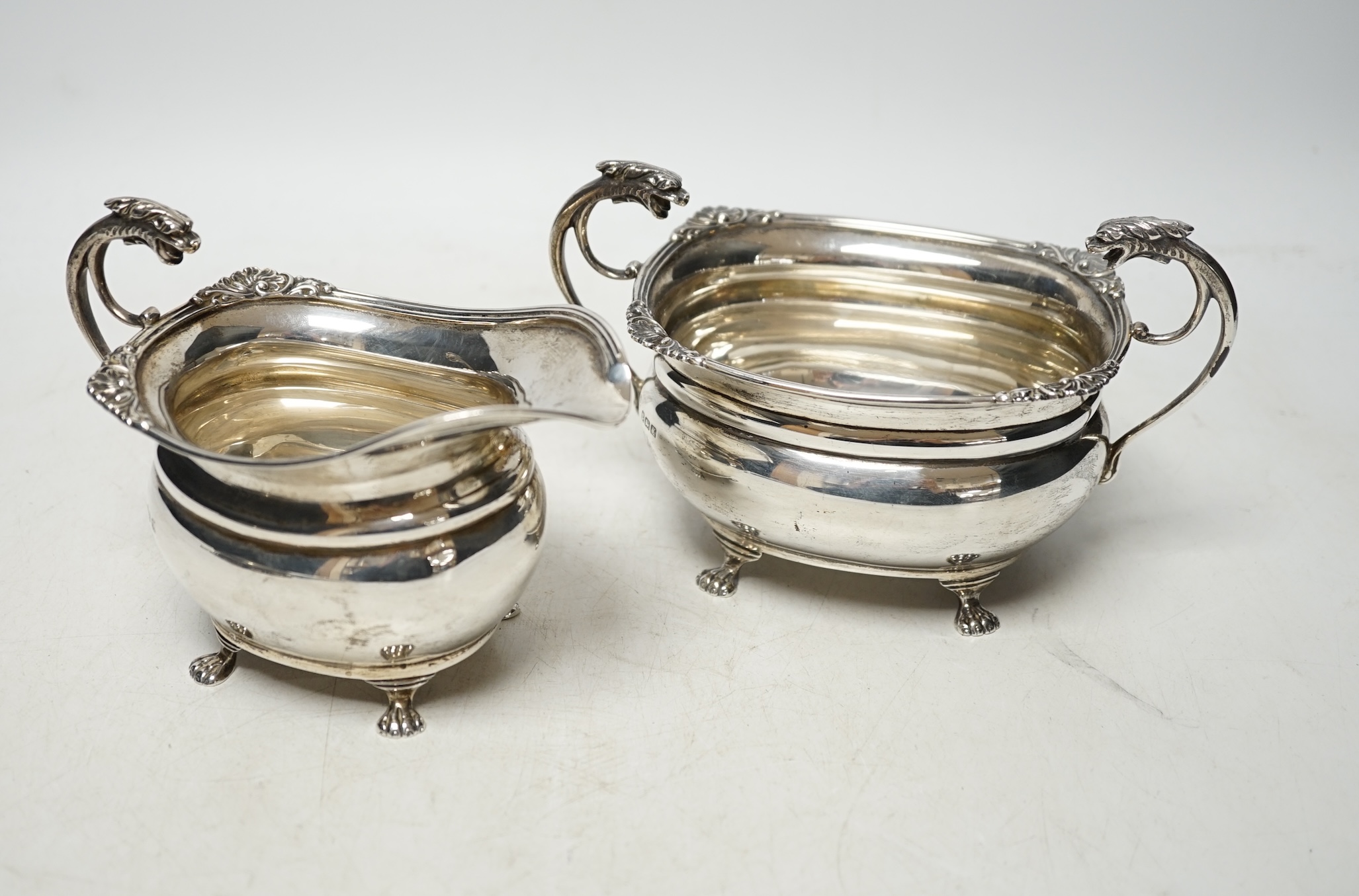 A George V silver cream jug and sugar bowl, by Alexander Clark Co. Ltd, Birmingham, 1922, 13.8oz. Condition - fair to good